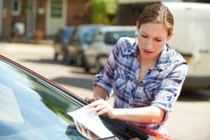 Frustrated Female Motorist Looking At Parking Ticket in Bergen County New Jersey